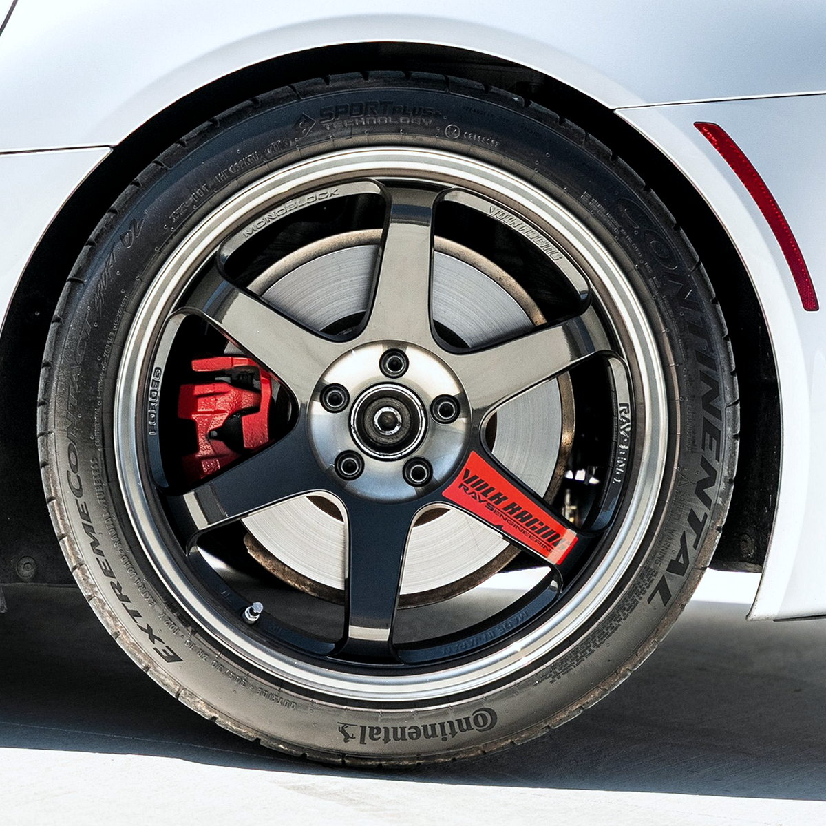 Gunmetal five-spoke alloy on a white car
